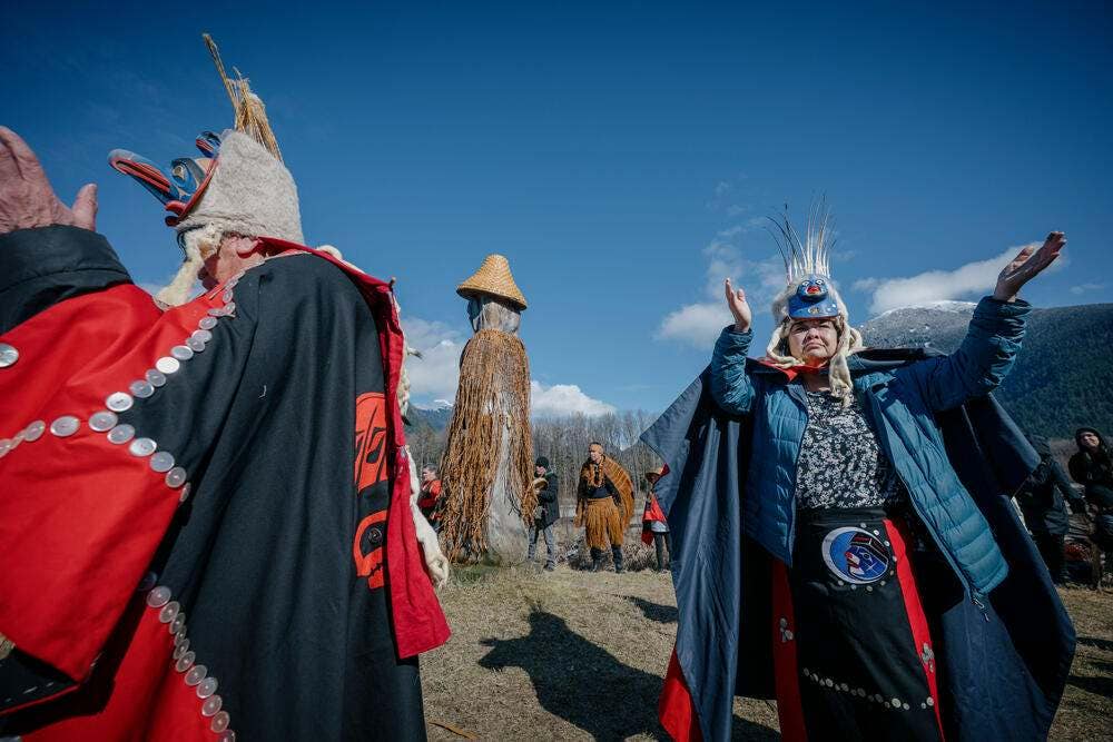 Nuxalk leaders dance at the sputc (eulachon) ceremony on the banks of the Bella Coola River, in the town of Bella Coola, on the central coast of British Columbia,  Canada.