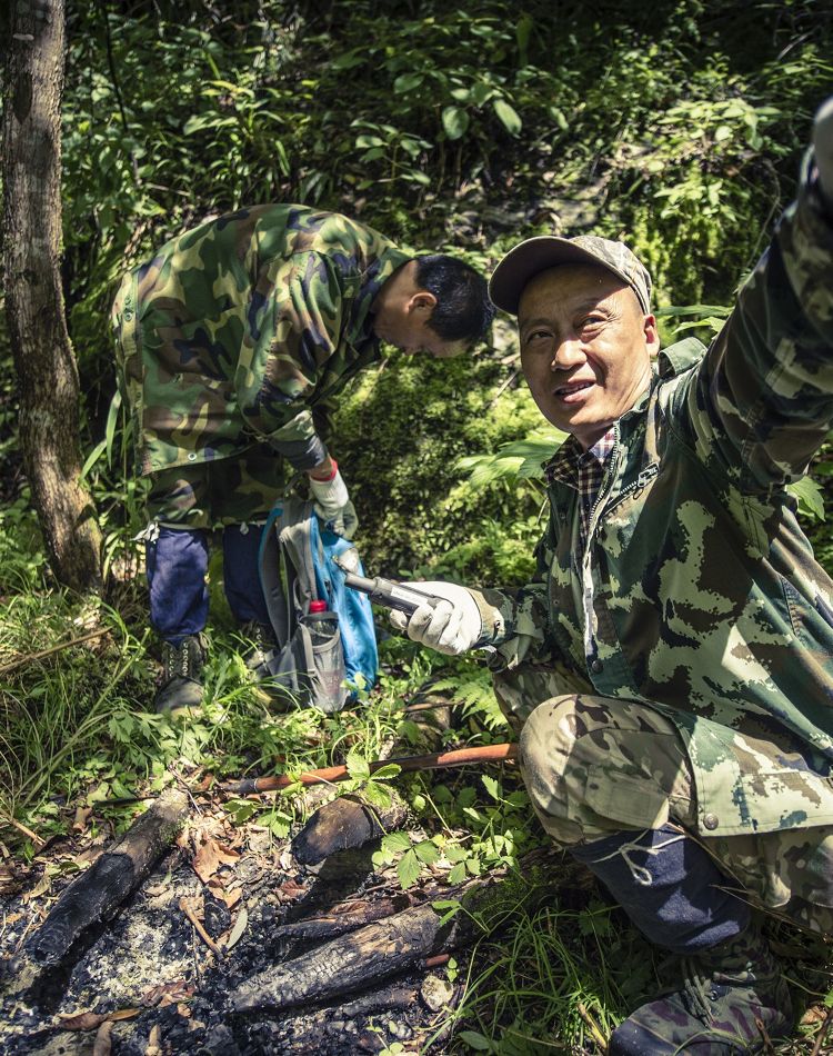 Rangers patrolling next to a fire pit.
