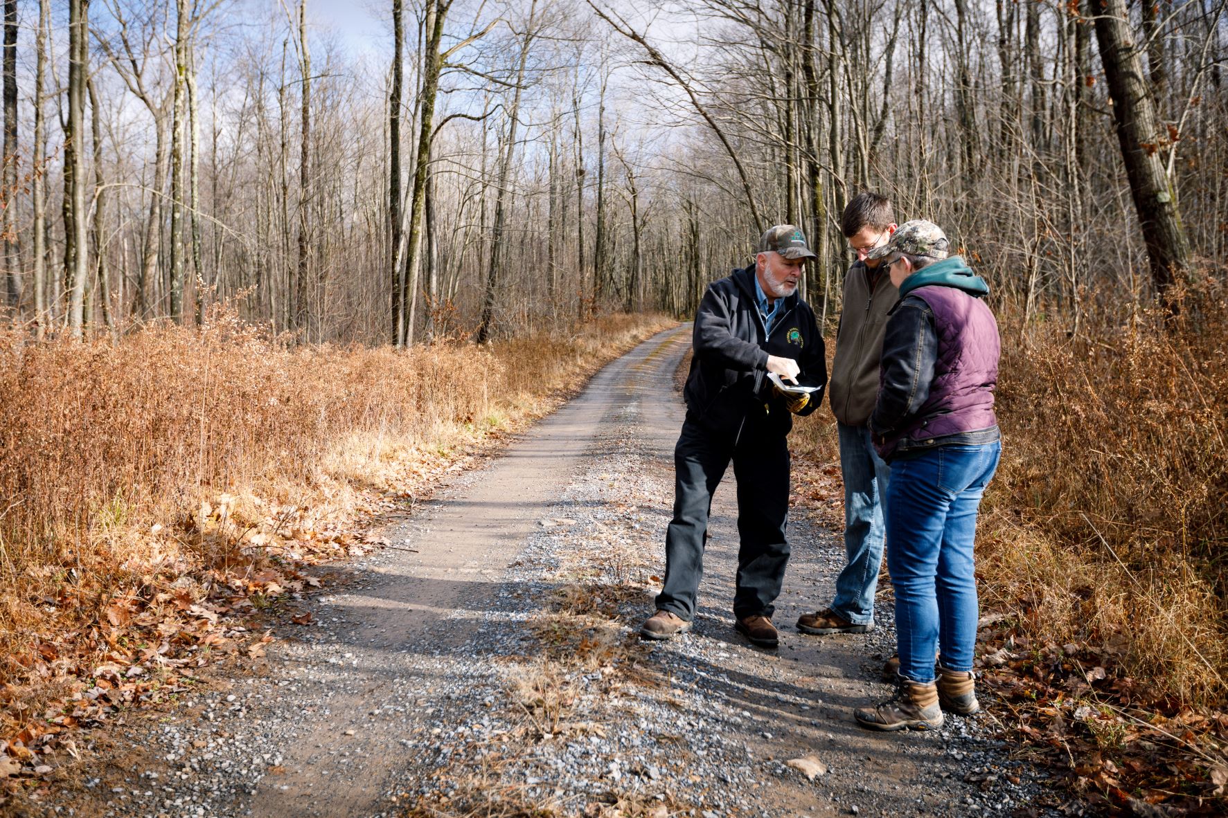 a group of people looking at a forestry map.