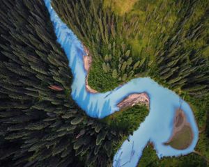 Parque Nacional Torres del Paine in Chile, showing sparkling waters of a bay and steep, snow-covered mountains in the distance.